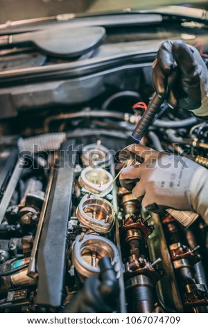 Working on the engine of a BMW
