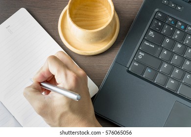 working on notebook and computer