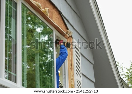  contractor working on replacing the window of the house