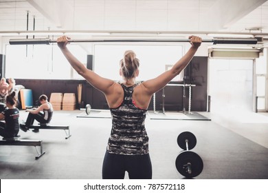 Working out in a cross fit box, lifting weights. - Shutterstock ID 787572118