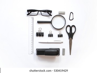 Working place composition with Pen, glasses , magnifier, scissors, line, stapler and other office decoration  on  white background, top view, flat lay