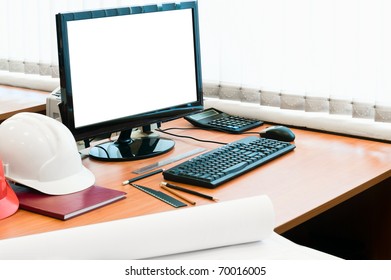 Working Place With Computer, Hard Hat And Project Drawings. White Isolated Screen