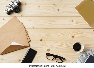 Working Place With Envelopes, Camera, Glasses And Smartphone On Wooden Table Top View Photo