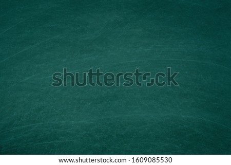 Working place on empty rubbed out on green board chalkboard texture background for classroom or wallpaper, add text message.