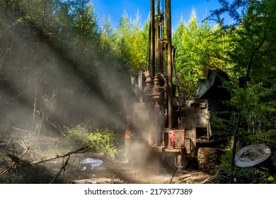 Working Process Of Drilling A Geological Well. Dust When Drilling Borehole. Drilling Rig In The Forest Is Drilling Well