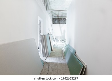Working process of installing metal frames for plasterboard - drywall for making gypsum walls in apartment is under construction, remodeling, renovation, extension, restoration and reconstruction.