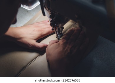 Working process of leather craftsman. Tanner sews leather on a special sewing machine, close up. Worker sewing leather product on the sewing machine. Leather worker workshop. - Powered by Shutterstock