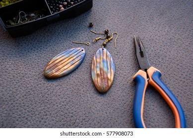 Working process making handmade earrings from polymer clay  Hobby  creativity background  Tools  pliers   jewelry finding 