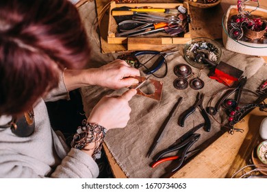 Working Process Making Jewelry For Wire Wrapped Bijouterie. Real Process. Craft Handmade Copper Wire Working Tools On The Table With Accessoires. Handicraft People Art Concept