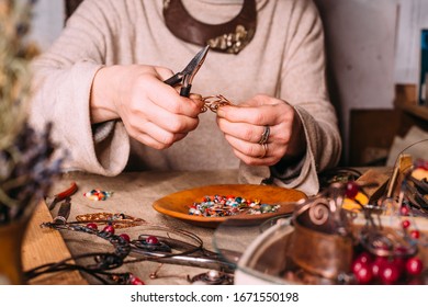 Working Process Making Jewelry For Wire Wrapped Bijouterie. Real Process. Craft Handmade Copper Wire Working Tools On The Table With Accessoires. Handicraft People Art Concept