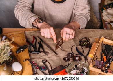 Working Process Making Jewelry For Wire Wrapped Bijouterie. Real Process. Craft Handmade Copper Wire Working Tools On The Table With Accessoires. Handicraft People Art Concept