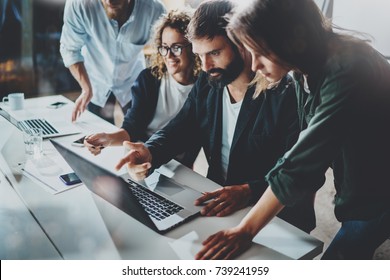 Working process at office.Group of young coworkers work together modern coworking studio.Young people making conversation with partners.Horizontal.Blurred background - Shutterstock ID 739241959