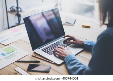 Working Process Photo.Woman Working Wood Table With New Business Project.Typing Contemporary Laptop, Reflections Screen.Modern Smartphone And Documents Table.Horizontal.Film Effect. Blurred Background