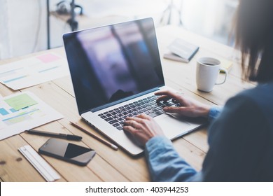 Working Process Photo.Woman Working Wood Table With New Business Project.Typing Contemporary Laptop, Reflections Screen. Modern Smartphone Table.Horizontal.Film Effect. Blurred Background