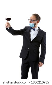 Working In Protective Face Mask. Portrait Of Male Sommelier, Wine Steward Or Bar Worker In White And Black Suit Isolated Over White Background. Copyspace For Ad. Concept Of Professional Occupation