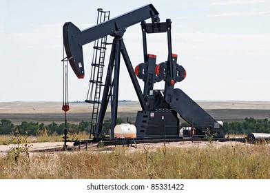 Working Pump Jack Pulling Crude Oil Out Of An Oil Well In Colorado, USA