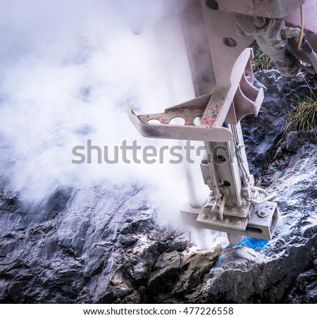 working rock drill at a mountain
