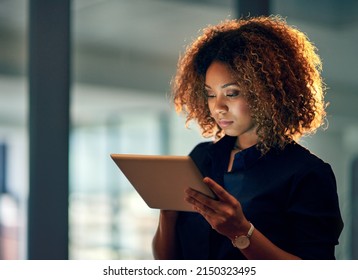 Working smart, working hard. Shot of a young businesswoman using a digital tablet during a late night at work. - Powered by Shutterstock