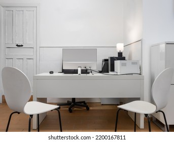 Working Station With A Desk, Two Chairs, Printer And Computer All In Black And White