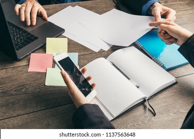 working strategy development decision and plans making. Top view. Male and female hands. Notepad is opened. - Shutterstock ID 1137563648