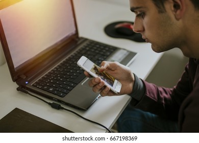 working or studying with the computer and the mobile phone man - Shutterstock ID 667198369