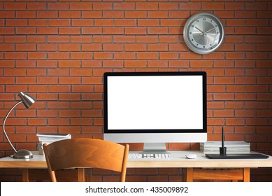 working table with computer on brick background