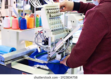 Working Technician Specialist Embroidery Industrial Machine In Sewing Workshop