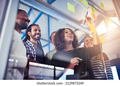 Working their way through different solutions. Shot of colleagues having a brainstorming session with sticky notes at work. - Powered by Shutterstock