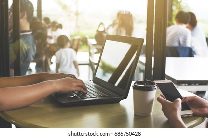 Working through a portable computer at a coffee shop