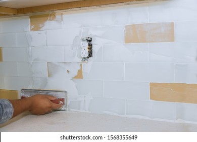 The Working Tile Grouting Applying Grout To The Joint Tiles For Home Improvements To A Kitchen