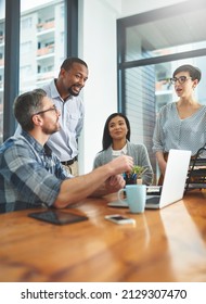 Working together to get the task done. Shot of businesspeople working together in the office.