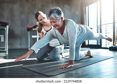 Working together to improve muscle strength and tone. Shot of a senior woman working out with her physiotherapist. - Shutterstock ID 2129744858
