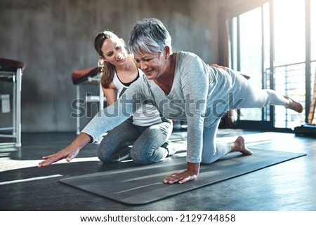 Working together to improve muscle strength and tone. Shot of a senior woman working out with her physiotherapist.