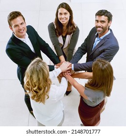 Working Together To Succeed Together. Portrait Of A Group Of Businesspeople Joining Their Hands Together In Unity.