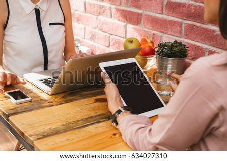 Working together. Tablet computer with blank screen