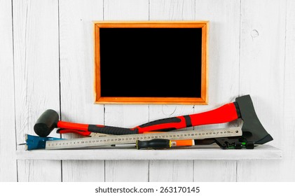Working tools and frame. On a white, wooden background.