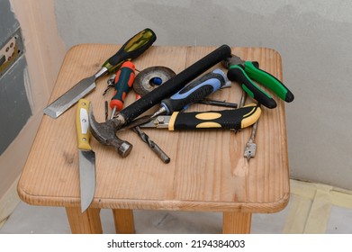 Working Tools Lie In A Chaotic Order On The Chair, Repairs In The House, A Variety Of Tools.