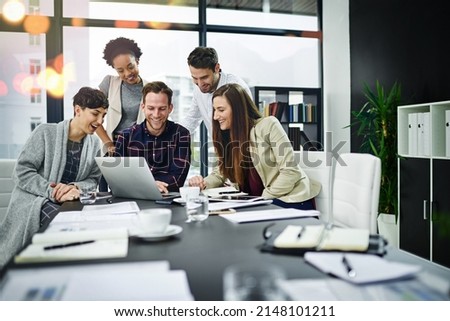 Working towards developing their skills together. Cropped shot of a group of businesspeople working together on a laptop in a modern office.