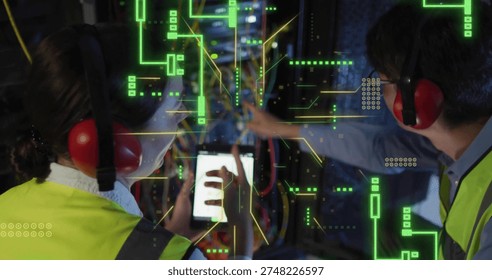 Working two technicians in hivis vests, red muffs, using tablet routing rack cables with AR overlay. Datacenter, networking, cabling, collaboration, lowlight, industrial, tech
