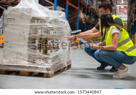 Working in warehouse, checking inventory