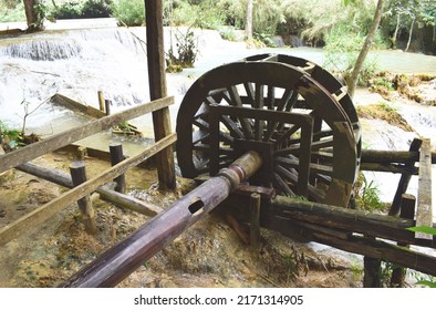 Working watermill wheel with falling water in the village.Laos PDR