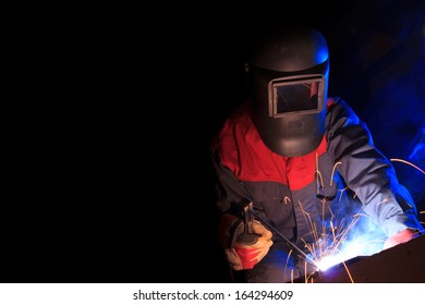 Working Welder On Black Background With Copy Space