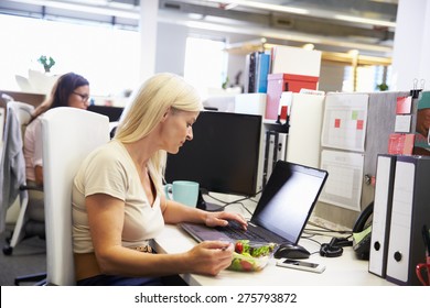 A Working Woman Eating Lunch At Her Desk