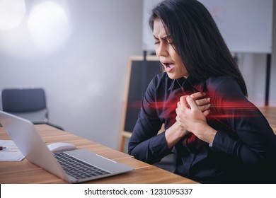 Working woman face suffering and holding breast because of heart infarction in office