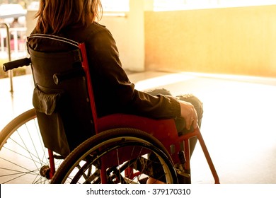 Working Woman On Wheelchair In Hospital, Warm Filter