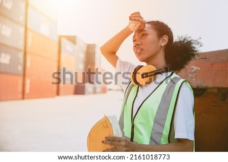 working woman worker work hard. black girl staff tired work in container port. teen lady working in danger area. young employee labor.