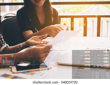 Working Women Are Discussing In Their Office With Stock Chart And Data Overlay