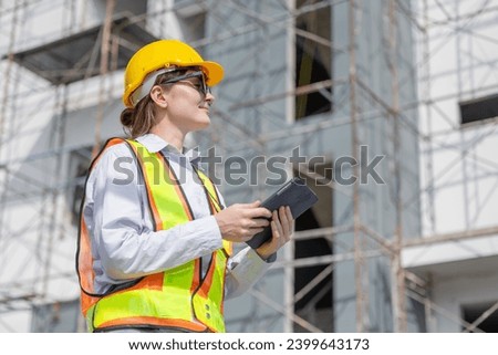 Working women Smart construction engineer caucasian female architect looking under construction building project.