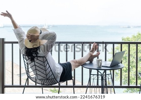 Work-life balance, relaxation healthy quality living lifestyle in summer holiday vacation of freelancer woman take it easy resting in resort hotel balcony with sea or ocean view having peace of mind