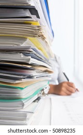 Workload Concept With High Pile Of Paperwork. Selective Focus